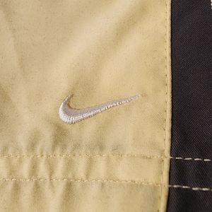 Nike track pants.Size 8-10 Medium.Light yellow with black and white stripe.